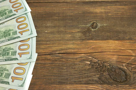 Five New One Hudred Dollar Bill On The Rough Wood Backgroundの写真素材