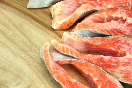 Fresh Raw Salmon Fish Steaks On Wood Cutting Board Close-upの写真素材