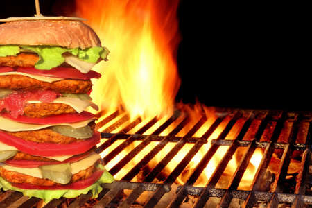 BBQ Homemade Big Cheeseburger  On The Hot Charcoal Grill. Flames of Fire In the Backgroundの写真素材