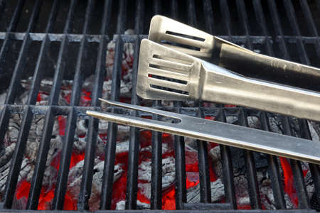 Empty Hot Flaming Charcoal Grill With BBQ Tools. Summer Outdoor Party Or Picnic Conceptの写真素材