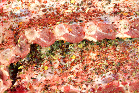 Raw Fresh Pork Baby Back Ribs With Seasoning Close-Up Backgroundの写真素材