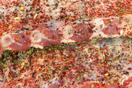 Raw Fresh Pork Baby Back Ribs With Seasoning Close-Up Backgroundの写真素材
