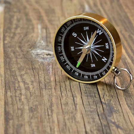 Gold Magnetic Compass On The Wood Board Background Close-upの写真素材