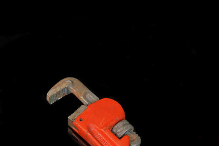Large Adjustable Wrench With Red Handle Isolated On Blackの写真素材