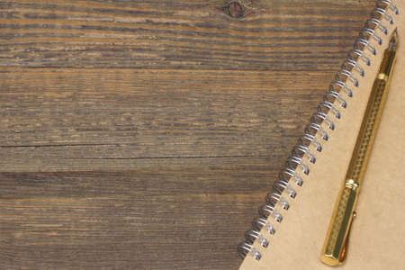 Notepad With Real 24k Gold Fountain Pen On The Old Rough Wooden Table Backgroundの写真素材