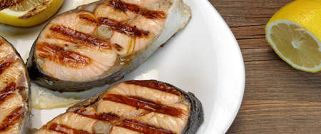 Close-up Of BBQ Grilled Salmon Steaks On The White Plate Backgroundの写真素材