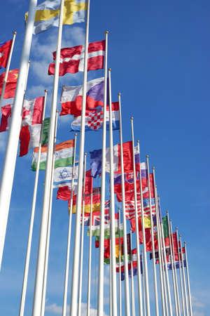 World Flags Blowing In The Wind On The Cloudy Sky Background