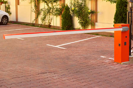 Automatic Rising Arm Barrier Closeup And Empty Private Area With Car Fragment In The Background