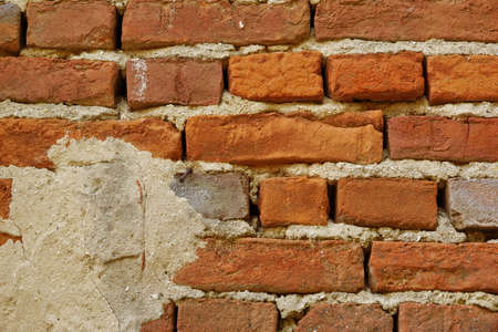 Old Uneven  Crumbling Red Brick Wall Background Textureの写真素材