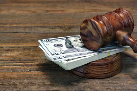 Close-up Of Judges Gavel, Soundboard And Bundle Of Dollar Cash On The Rough Wooden Table. Concept For Corruption, Bankruptcy Court, Bail, Business Or Financial Crime, Bribing, Fraud, Auction Biddingの写真素材