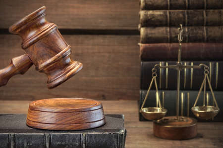 Closeup Of Judges Gavel, Legal Code, Scales Of Justice On The Rough Wooden Background. Law Concept