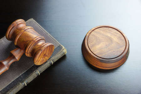Judges  Or Auctioneers Walnut Gavel And Old Law Book  On The Black Wooden Table Background In The...