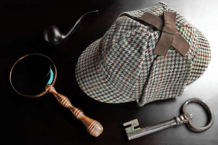 Sherlock Holmes Deerstalker Hat Smoking Pipe, Old Key And Vintage  Magnifying Glass On The Black Wooden Table Background. Overhead View.  Investigation Concept.の写真素材