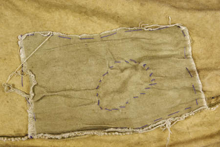 Weathered Military Army  Khaki Camouflage Fabric With Patch, Background Texture, Close Up, Top View