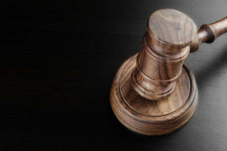 Judges Or Auctioneers Walnut Gavel And Sound Block On The Empty Black Table In The Back Light....