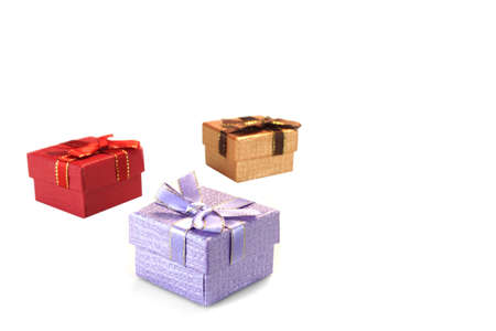 Close Up Of Three Violet, Golden And Red Gift Boxes With Ribbon And Bow, Isolated On White...