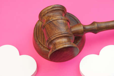 legalities Of Divorce Concept. Judges Gavel And Two White Hearts Isolated On Pink Background. Top...