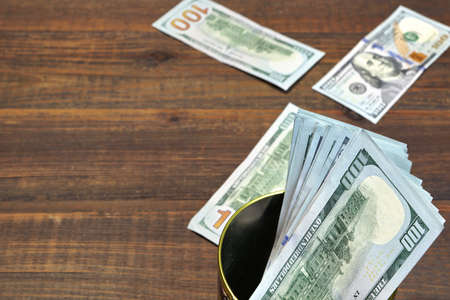 American One Hundred Dollar Bills In The  Tin Can Top View On The Rough Wooden Table Background With...