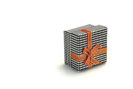 Close Up Of Single Gift Box With Dotted Black White Pattern, Orange Ribbon And Bow, Isolated On...