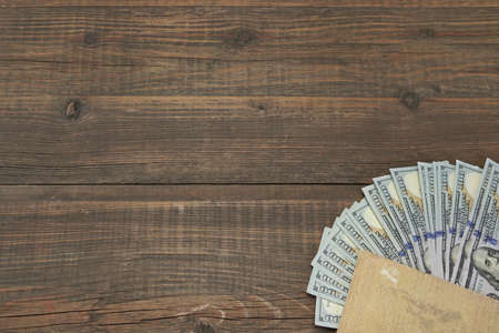 Notepad With American Dollar Cash On The Rough Rustic  Brown Wood Baclground With Copy Space, Conceptual Image For Home Or Own Financeの写真素材