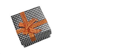 Close Up Of Single Gift Box With Dotted Black White Pattern, Orange Ribbon And Bow, Isolated On...