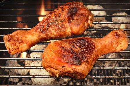 BBQ Chicken Legs Roasted On The Hot Flaming Charcoal Grill, Top View Close Upの写真素材