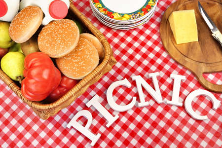 Sign Picnic Made From White Letters On The Table With  Red Checkered Tablecloth And Lunch In Basket, Top Viewの写真素材