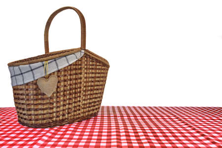 Picnic Basket On The Red Checkered Tablecloth Isolated On White Backgroundの写真素材