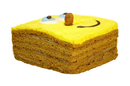 Close-up Of Single Brownie Cake With Human Smiling Yellow Face Isolated On White Background