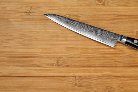 Single Japanese Professonal Long Kitchen Knife On The Bamboo Empty Cutting Board, Top View, Close...