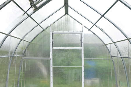 The interior of the greenhouse is made of metal profiles and polycarbonate sheetsの写真素材
