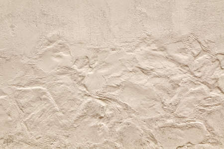 Brick Wall Fragment With Decorative  Beige Finishing Plaster And  Abstract Application Pattern Textured Horizontal Backgroundの写真素材