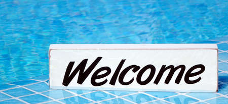 Welcome Sign On The White Board In The Water Swimming Pool Surface, Sport Competition Conceptの写真素材