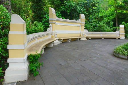 Antique Yellow Stone Bench In The Public Botanical Park And Tropical Summer Garden In The Background, Russia, Sochiの写真素材