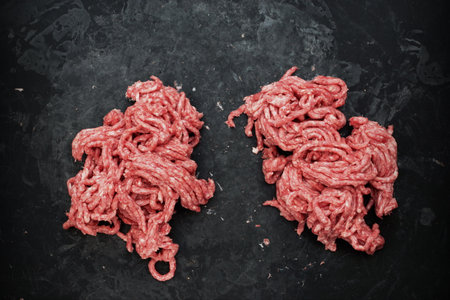 Raw Minced Meat On Black Vintage Background. Top View Of Fresh Ground Beef Isolated On Black Background. Uncooked Minced Mixed Beef And Pork Meat.の写真素材