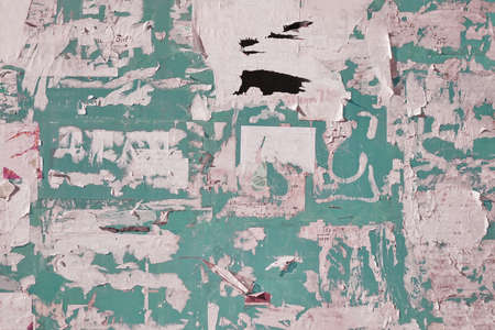 Old Billboard with Torn Posters. Dirty Street Wall with Crumpled, Wrinkled, Creased, Worn and Torn Posters. Abstract Vintage Background and Texture.の写真素材