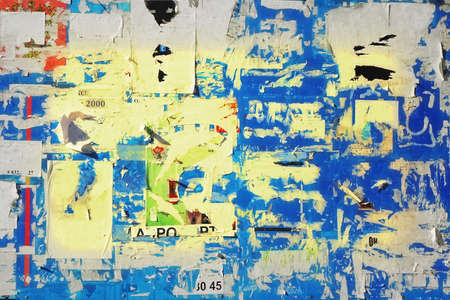 Old Billboard with Torn Posters. Vintage Background and Texture for text or image. Urban Wall with...