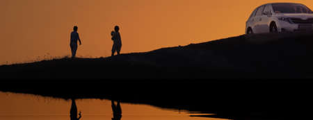 Black Silhouette Or Contour Of Couple Which Take Photo. Man And Woman Traveling On SUV Car In Europe. Family Adult Couple Meet Bright Sunrise Or Sunset At Sea Coast Or Lake.の写真素材