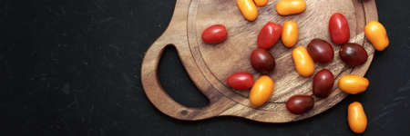 Plum Cherry On White Round Cutting Board. Assorted Plump Cherry Tomatoes On Wooden Cutting Board....