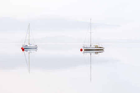 Couple of boats in a misty dayの写真素材