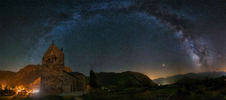 Milky way arch over Torre de Barrio village in Leon, Spain