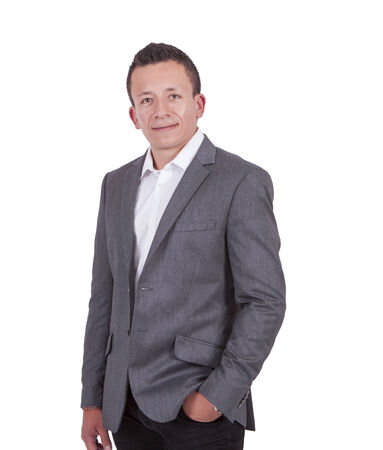 Portrait of a handsome young businessman posing against whiteの写真素材