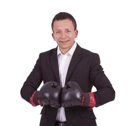 Portrait of a smiling young businessman with boxing gloves posing against whiteの写真素材