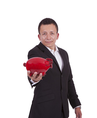 Portrait of a handsome young businessman posing with a piggy bankの写真素材