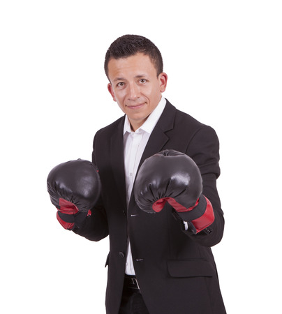 Young mixed race businessman with boxing gloves posing against whiteの写真素材