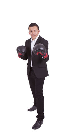 Image of a young businessman with boxing gloves ready to fightの写真素材