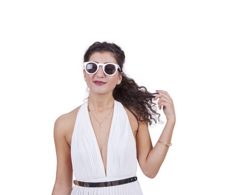 Image of an attractive young female wearing sunglasses and posing against white backgroundの写真素材
