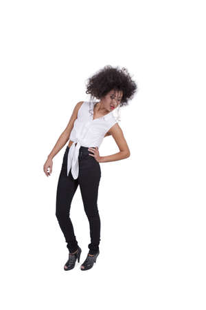 Attractive young woman posing with hand on hips against white backgroundの写真素材