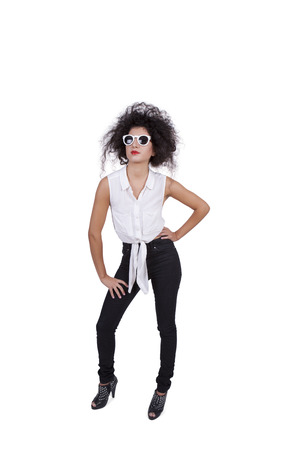 Image of an attractive young woman posing with sunglasses against white backgroundの写真素材