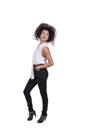 Side view of a beautiful young female posing against white backgroundの写真素材